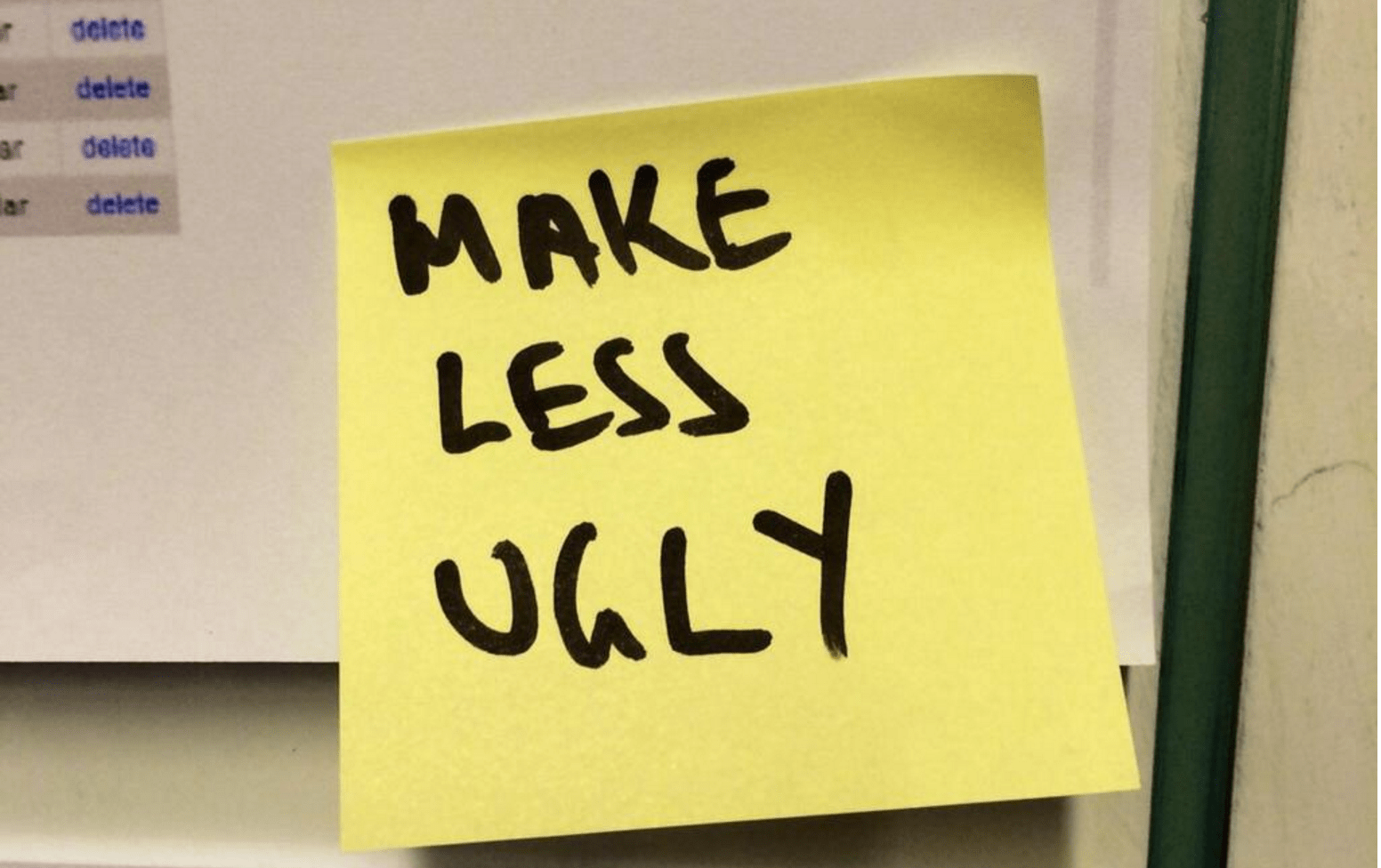 a yellow sticky note attached to a computer screen with handwriting on it that says 