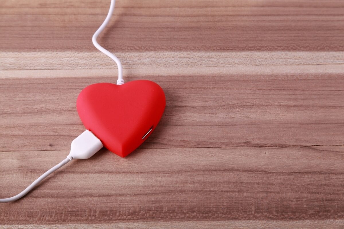 a computer power cord plugged into a heart-shaped pillow