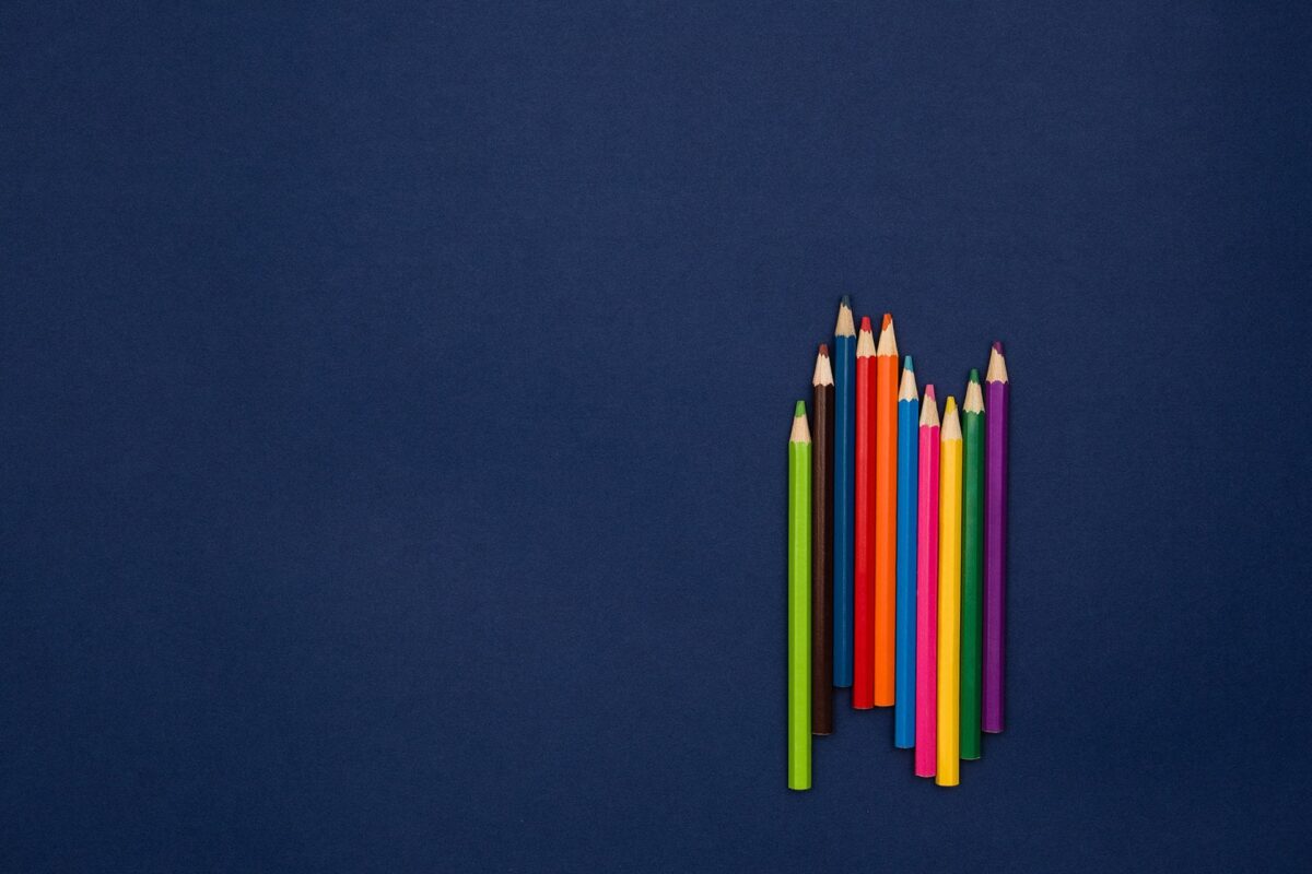 a group of colored pencils